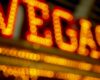 Blurred warm orange neon signs creating a glowing bokeh backdrop at night