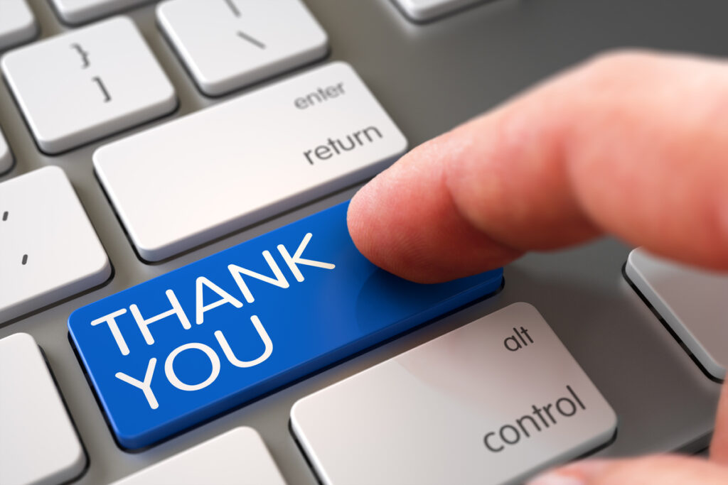 Blue 'THANK YOU' key being pressed on a keyboard, symbolizing gratitude or appreciation.