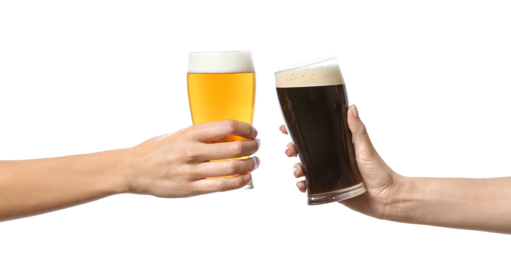Two hands clinking beer glasses—one pale ale and one dark stout against a white background.