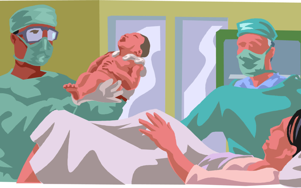 Delivery scene with surgeons in scrubs and masks assisting a newborn being born in a hospital delivery room.