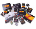 Collection of Metallica Reload-era memorabilia: CDs, vinyl sleeves, booklets and posters scattered around.
