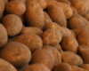 Pile of unwashed brown potatoes stacked together